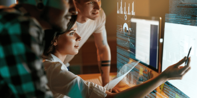 three people working on computer